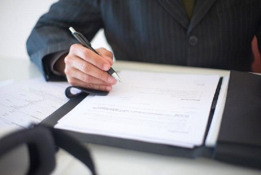 A man signing a document